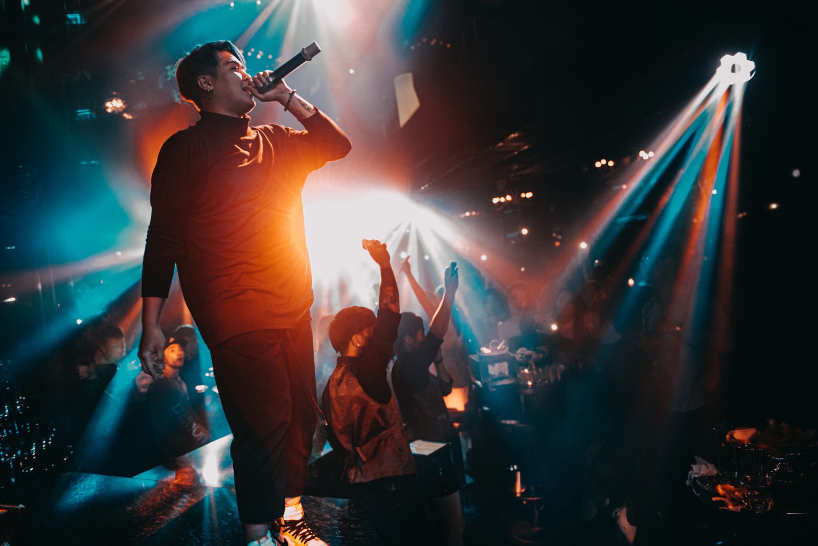 Artist performing live on stage at an event managed by Tingle Works